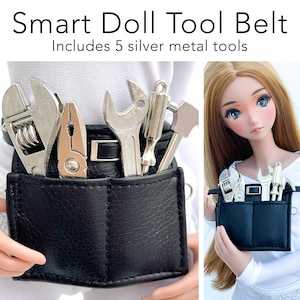 May include: Black leather tool belt with five silver metal tools, including a wrench, pliers, screwdriver, and hammer. The text "Smart Doll Tool Belt" and "Includes 5 silver metal tools" is printed above the belt.