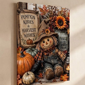 May include: A canvas wall art print featuring a scarecrow wearing a burlap hat and plaid scarf, sitting among pumpkins, a black crow, and a metal pitcher. The text reads PUMPKIN KISSES & HARVEST WISHES and FALL IS MY FAVORITE COLOR.