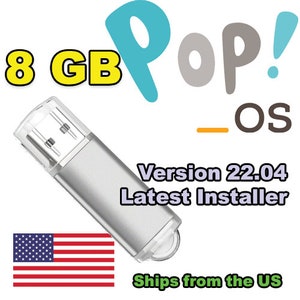 May include: Silver USB flash drive with the text "8 GB" and "Version 22.04 Latest Installer." The image also includes the words "Pop!_OS" and the American flag.