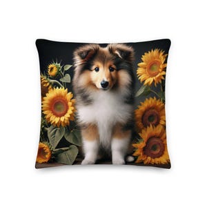 Puede incluir: Un cachorro de Shetland Sheepdog marrón y blanco se sienta en un campo de girasoles. El cachorro está mirando directamente a la cámara. Los girasoles están en plena floración y tienen pétalos amarillos y centros marrones.