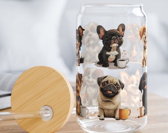 May include: A clear glass can with a bamboo lid and a straw. The can has a pattern of cartoon dogs with coffee cups. The dogs are a pug, a french bulldog, and a chihuahua.