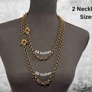 May include: Two antique brass-colored chain necklaces, 24 and 30 inches long, displayed on a black mannequin. Each necklace has a toggle clasp. The image includes the text "2 Necklace Sizes".