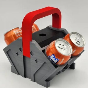 May include: A gray and red six-pack can holder with a red handle. The holder is designed to hold six cans of soda or beer. The cans are not included.