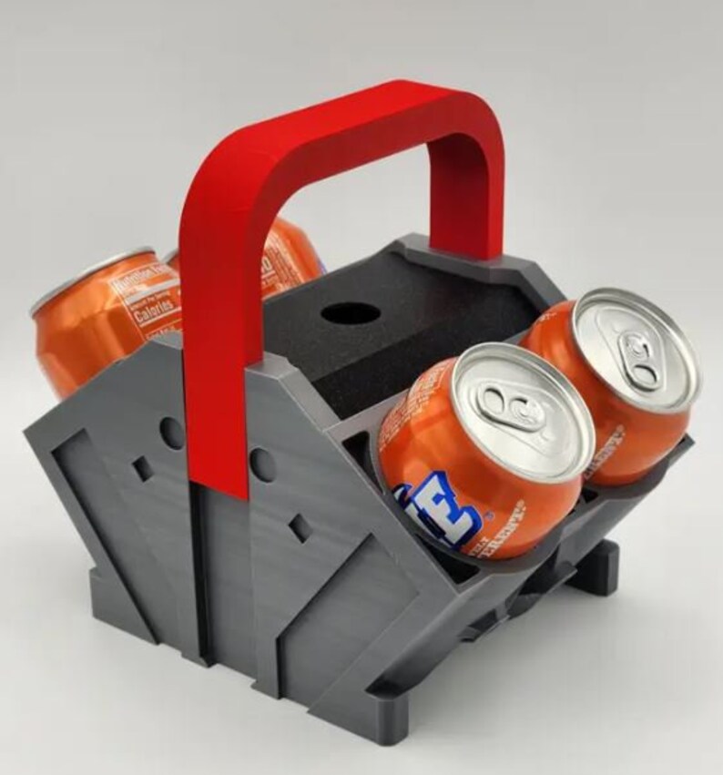 May include: A gray and red six-pack can holder with a red handle. The holder is designed to hold six cans of soda or beer. The cans are not included.