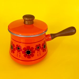 May include: Orange enamel saucepan with a wooden handle and lid. The saucepan features a floral pattern in red and black.
