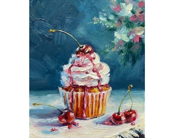 May include: Oil painting of a cupcake with white frosting and cherry topping. The cupcake sits on a white cloth with two cherries nearby. A bouquet of flowers is in the background. The painting has a blue background.