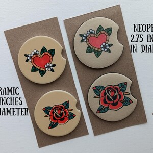 May include: Four round coasters with different designs. Two coasters feature a red heart with green leaves and white flowers. The other two coasters feature a red rose with green leaves. The coasters are on a brown background. The text "NEOPRENE 2.75 INCHES IN DIAMETER" and "CERAMIC 2.5 INCHES IN DIAMETER" are visible.
