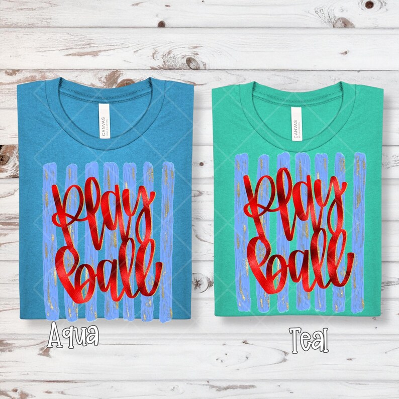 May include: Two t-shirts, one aqua and one teal, each with the words "Play Ball" in red script. The shirts have a crew neck and a design of blue vertical stripes with gold accents.