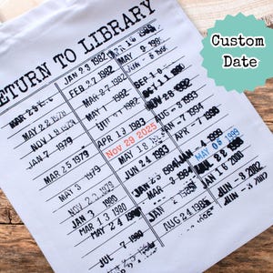May include: White canvas tote bag with black text reading "RETURN TO LIBRARY" and a custom date stamp. The design resembles a library checkout card, with rows of dates. The custom date is highlighted in red.