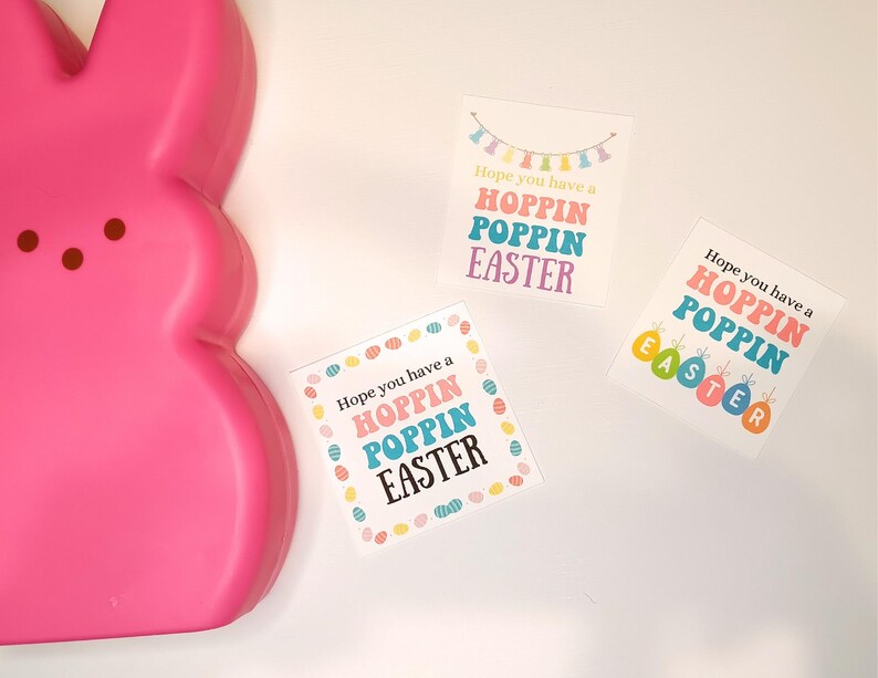 May include: Three Easter gift tags with the text "Hope you have a Hoppin Poppin Easter" in colorful letters and a string of colorful flags above the text. The tags are on a white background.