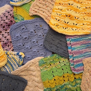 May include: A collection of colorful, hand-knitted squares in various textures and patterns. The squares are in shades of blue, yellow, green, and beige, with some featuring openwork designs. The image showcases the variety of textures and colors.