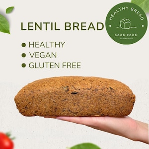 May include: A loaf of lentil bread, brown in color, is held in a hand. The text on the image reads "Lentil Bread", "Healthy", "Vegan", "Gluten Free", "Healthy Bread", "Good Food", and "Gluten Free".