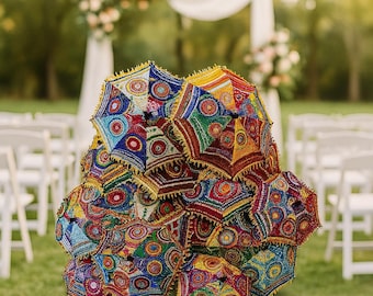 May include: A pile of vibrant, patterned decorative umbrellas with beaded edges. The umbrellas display a range of colours, such as blue, red, yellow, and green. The background shows a wedding ceremony setting with floral decorations.