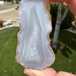 Agate with crystal center and fortification bands. From agate desert in southern Oregon. Tumbled to show character of the rock.