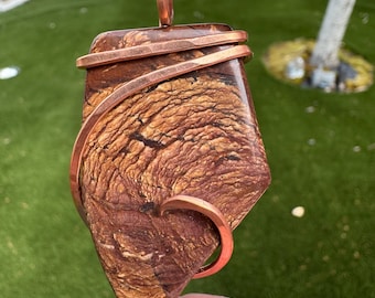 Jasper pendant from Biggs Junction, Oregon. Collected, cut, and tumbled to show its petrified mud flow patterns hammered copper.