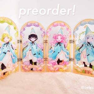 May include: A four-panel acrylic folding screen featuring anime-style characters Coco, Agott, Tetia, and Richeh in blue capes and hats. Each panel has a decorative arch, pastel ribbons, and floral accents. The text reads preorder and @celesztiql.