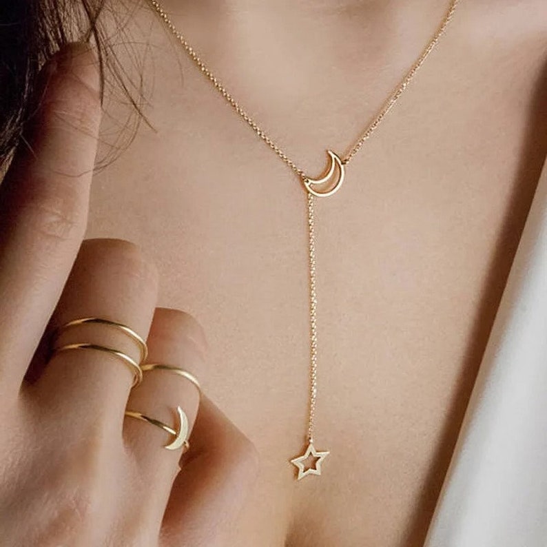 Elevate your style with the Starry Elegance: New Moon Star Pendant Choker. A simple gold alloy charm chain collares necklace for women, making it the perfect party jewelry piece.
