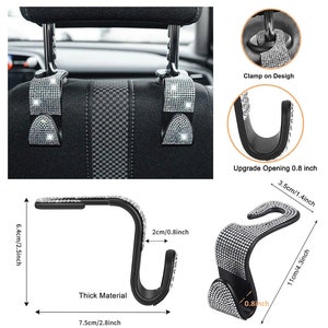 May include: Two black car seat headrest hooks with a diamond-like design. The hooks are 2.5 inches tall, 2.8 inches wide, and have a 1.4 inch opening. The hooks are shown in a car and on a white background.