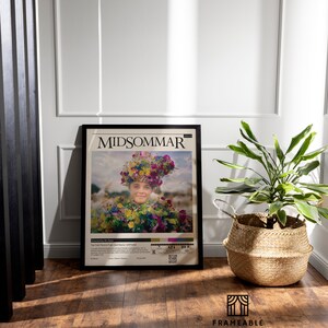 May include: A black framed movie poster for the film "Midsommar" featuring a woman wearing a flower crown and a floral dress. The poster has a rating of R and a release date of July 3, 2019.