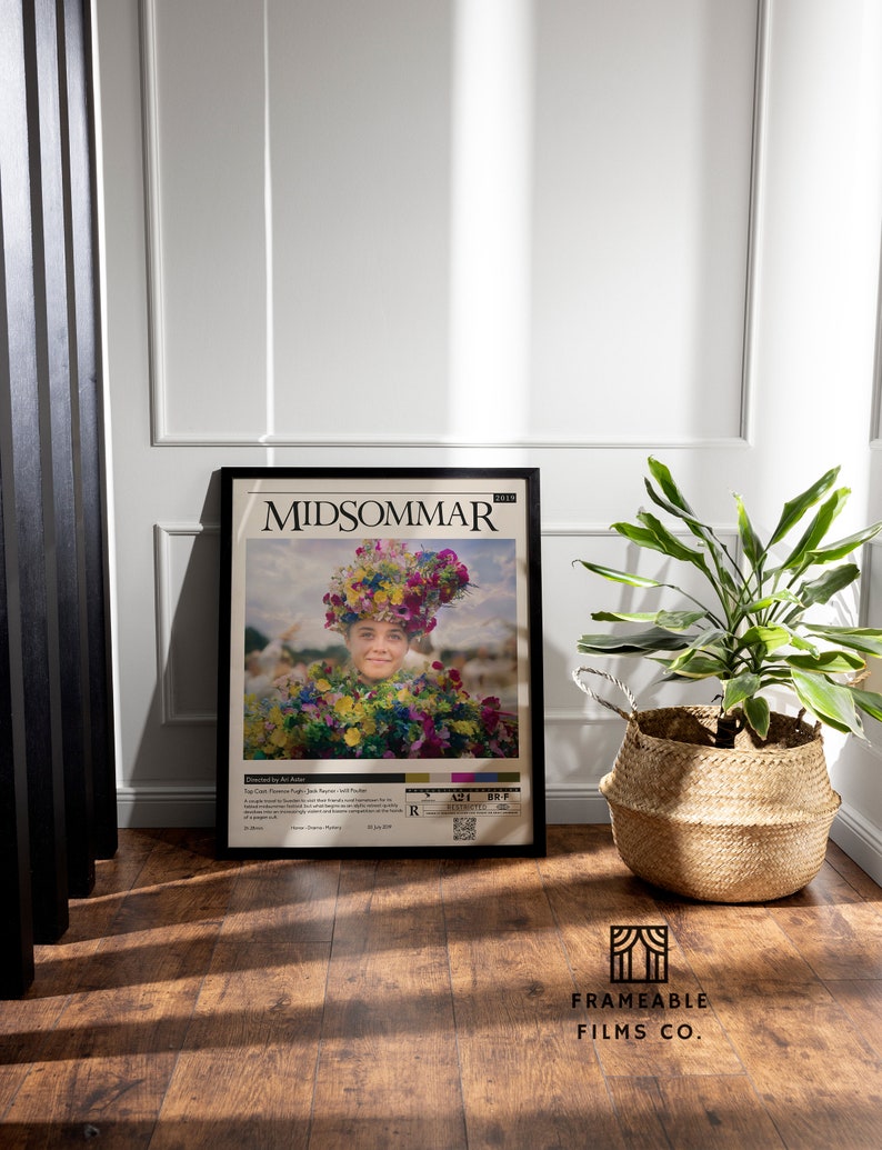 May include: A black framed movie poster for the film "Midsommar" featuring a woman wearing a flower crown and a floral dress. The poster has a rating of R and a release date of July 3, 2019.