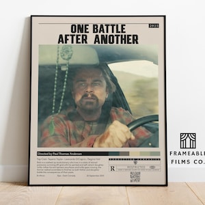 May include: Framed movie poster with the title "One Battle After Another" and a photo of a man driving a car. The poster includes the director's name, cast, and a rating.