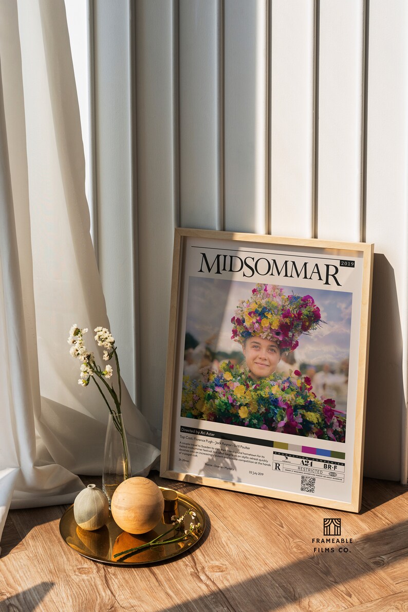 May include: A framed movie poster for the 2019 film "Midsommar" directed by Ari Aster. The poster features a woman wearing a flower crown and a floral dress. The poster also includes the film's title, director, and release date.