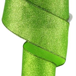May include: A spool of lime green glitter ribbon. The ribbon is 2.5 inches wide and has a wired edge.