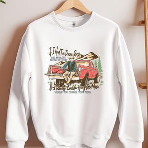 May include: White sweatshirt with a vintage-style graphic of a person sitting in the back of a red pickup truck. The text reads "If I had two dozen roses and an older bottle of wine, If I really coulda hung the moon, would you change your mind."