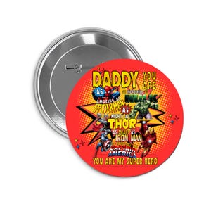 May include: A round, red button with the text "DADDY YOU ARE MY SUPER HERO" and images of Marvel superheroes. The button features Spider-Man, Hulk, Thor, Iron Man, and Captain America. The button has a silver metal backing.