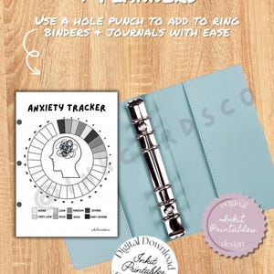 May include: Anxiety tracker printable with a circular design, featuring a head silhouette and a scale from none to very severe. The tracker is shown inside a light blue binder with a silver ring mechanism. The text reads "Perfect for Journals + Planners."