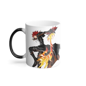 May include: White ceramic mug featuring a dynamic anime character with red hair and a black outfit. The character is holding a fiery weapon. The mug's handle is black, and the interior is white.