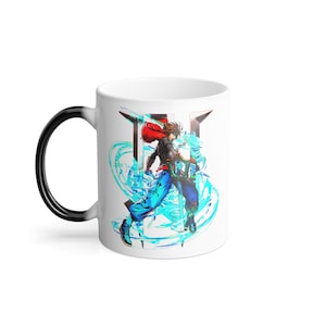 May include: White ceramic mug with a black handle. The mug features a colorful illustration of a character from a video game, surrounded by blue and white swirling energy. The character is holding a sword and has red hair.