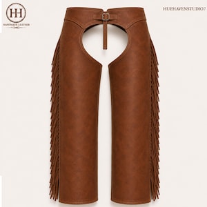 May include: Brown leather chaps featuring long fringe detailing along the outer legs, a high-waisted design with a central buckle closure at the waist, and a vertical strap connecting the waistband to the front opening. Text reads HH Handmade Leather.