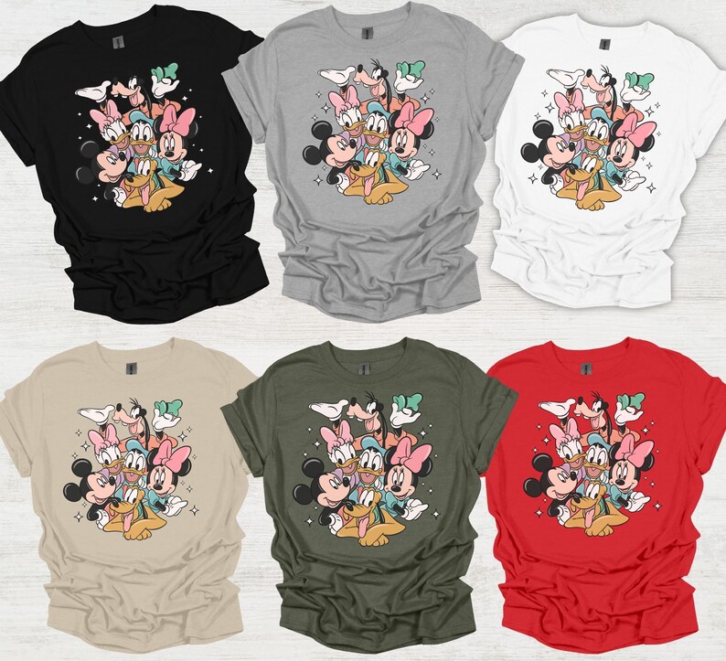 May include: Six t-shirts in various colors: black, gray, white, tan, olive green, and red. Each shirt features a graphic of Mickey Mouse, Minnie Mouse, Donald Duck, Daisy Duck, Goofy, and Pluto. The cartoon characters are clustered together.