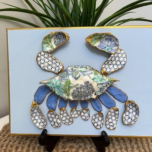 Beautiful crab picture using decoupaged shells, gilded on the edges, and mounted on a 9x12&quot; canvas, unique coastal decor