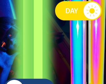 May include: Image features two glowing, iridescent light sticks with black handles and yellow tips. The sticks have a rainbow effect. The image also includes a yellow button with the word "DAY" and a sun icon, and a blue button with the word "NIGHT" and a moon icon.
