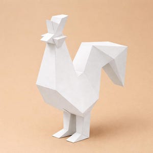 May include: A white, geometric paper rooster sculpture. The sculpture has a polygonal design, with sharp angles and flat surfaces. The rooster is standing on two legs, with a tall comb and a curved tail. The background is a solid, light peach color.