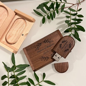 May include: A wooden box with a USB drive inside. The USB drive is engraved with the text "Andrew & Madison 10.28.23".