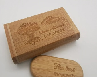May include: A rectangular bamboo box and a matching oval bamboo USB drive. The box features an engraved tree, two interlocking rings, and the text "Dario e Eleonora 05/08/2022". The USB drive is engraved with the text "The best moments".