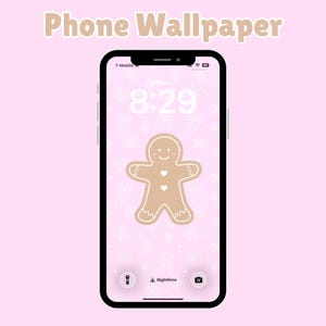 May include: A smartphone shows a gingerbread man wallpaper on a pink background with snowflakes. The time is 8:29. The phone's screen is black with a white border. The words "Phone Wallpaper" are at the top.