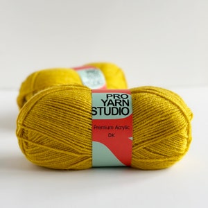 May include: Two skeins of yellow yarn labeled "Pro Yarn Studio" Premium Acrylic DK.