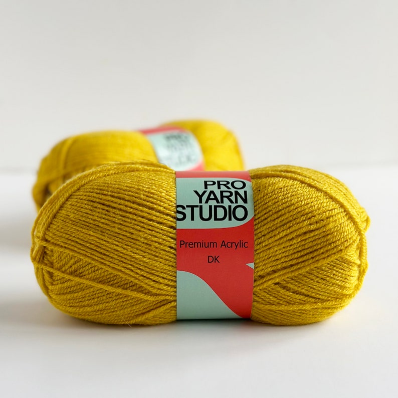May include: Two skeins of yellow yarn labeled "Pro Yarn Studio" Premium Acrylic DK.