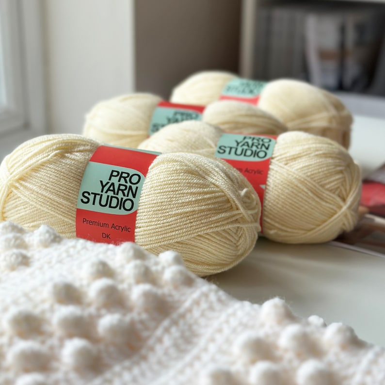 May include: Four skeins of cream-colored yarn with the label "PRO YARN STUDIO" and "Premium Acrylic DK".
