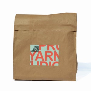 Paper sack that the learn to crochet blanket kit comes in.