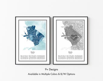 May include: Two framed wall art prints featuring maps of Manila, Philippines. The left print displays a blue patterned map on a light blue background, while the right print shows a black and white street map. Both include text labels.