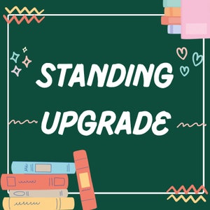 May include: A green chalkboard with the text "STANDING UPGRADE" written in white. The chalkboard is surrounded by a white frame and decorated with colorful doodles, including stars, hearts, and wavy lines. A stack of colorful books is on the left side of the chalkboard, and another stack of books is on the right side.