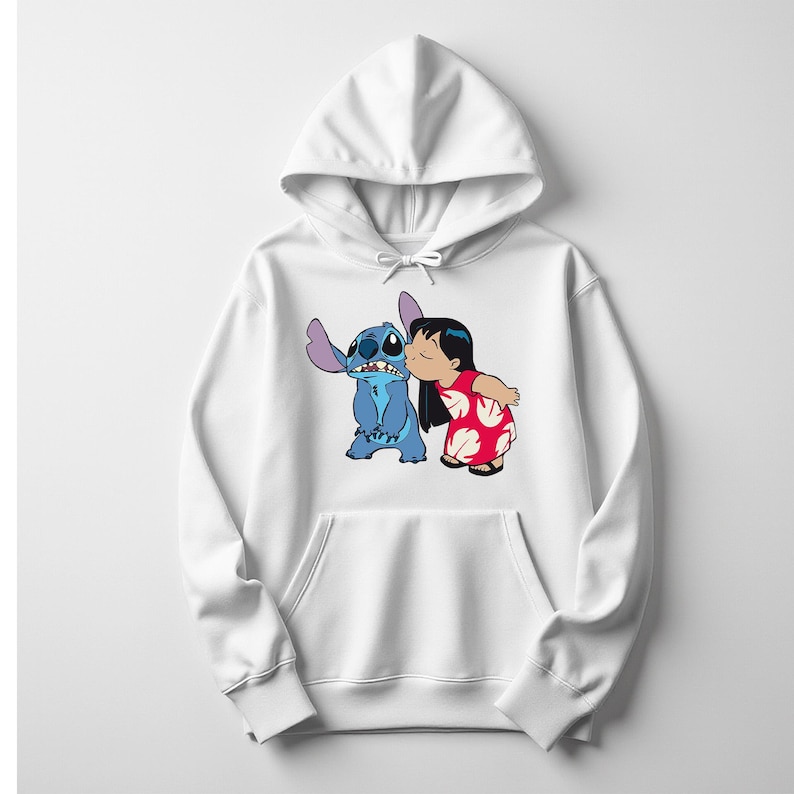 May include: White hooded sweatshirt featuring a graphic of Stitch and Lilo from the Disney movie Lilo & Stitch. Stitch is blue, and Lilo is wearing a red dress with white floral patterns. The design is centered on the front of the sweatshirt.
