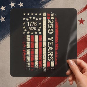May include: A black square with a distressed American flag design. The flag features red and white stripes, stars, and the years 1776 and 2026. The text "250 YEARS" is printed vertically on the right side.