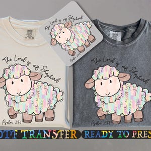 May include: A DTF transfer design featuring a cute cartoon lamb with a rainbow-coloured wool pattern. The design includes the text "The Lord is my Shepherd" and "Psalm 23:1".