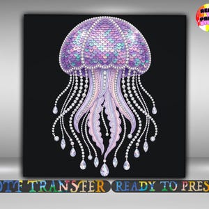 May include: A digital illustration of a jellyfish with a black background. The jellyfish is primarily purple, with a scaled top and beaded strands. The tentacles are adorned with teardrop-shaped gems. The words "DTF TRANSFER" and "READY TO PRESS" are at the bottom.